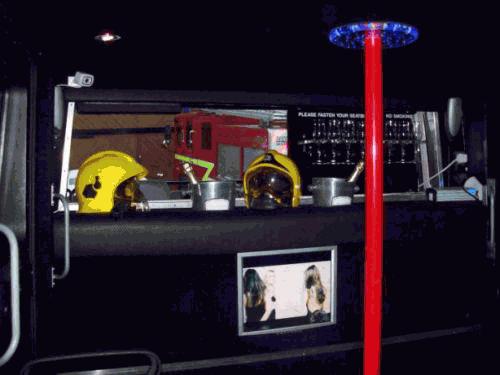 Chauffeur driven Fire Engine red limousine interior with real firemen for hire in London.