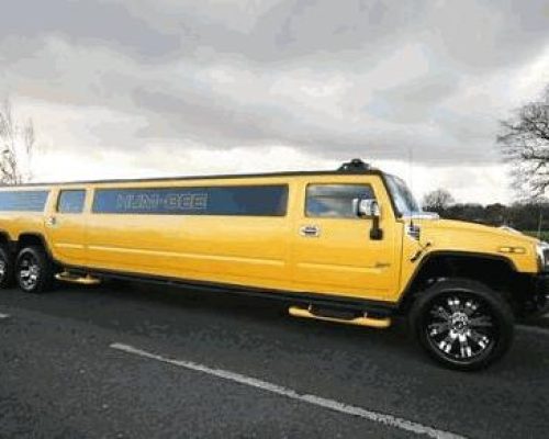 Chauffeur stretched yellow 8-wheeler triple axle H2 hummer limo in London.